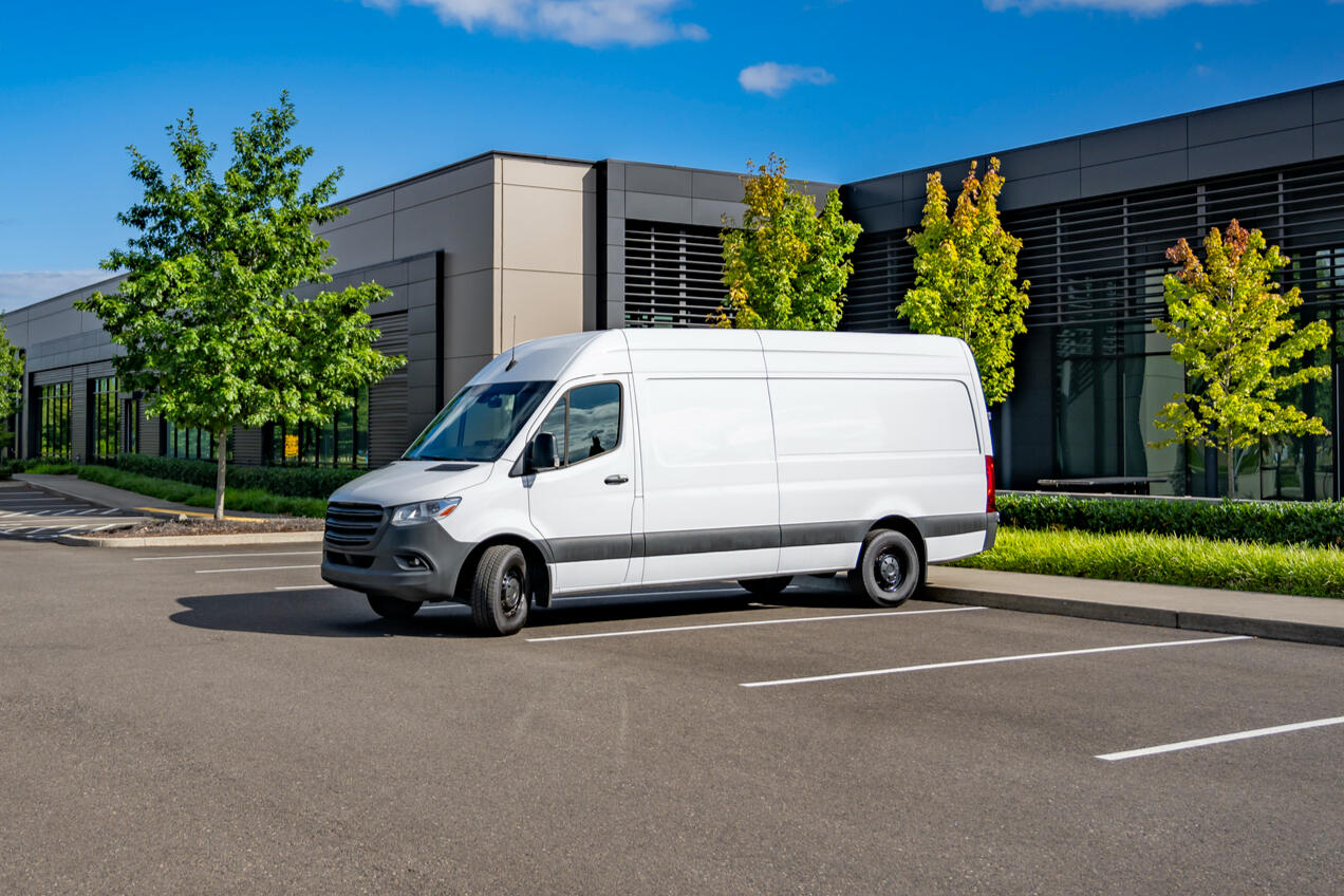 Hero Picture Hero Picture of a standard delivery van near a business office setting.
